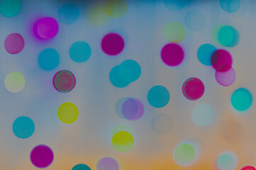 Many-sided bright multicolor bokeh spots from car agnei on a contrasting black background