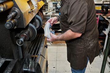 shoemaker man working in his shoe shop