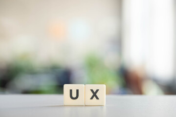 white blocks with ux lettering on office desk