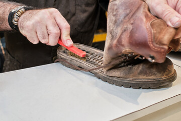 shoemaker man working in his shoe shop