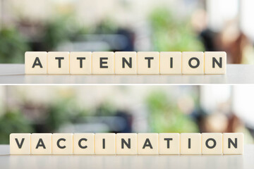 collage of white cubes with attention, vaccination lettering on white desk, covid-19 concept