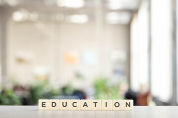 white blocks with education lettering on white desk