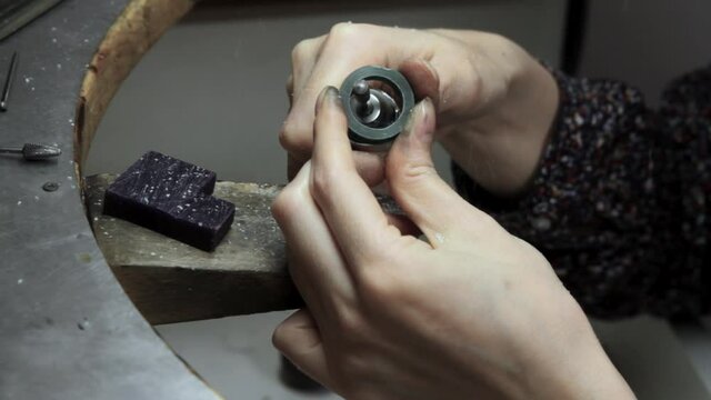 Profession jeweler. Craft jewelry making. Hands of an jeweller . Handwork . Close up.