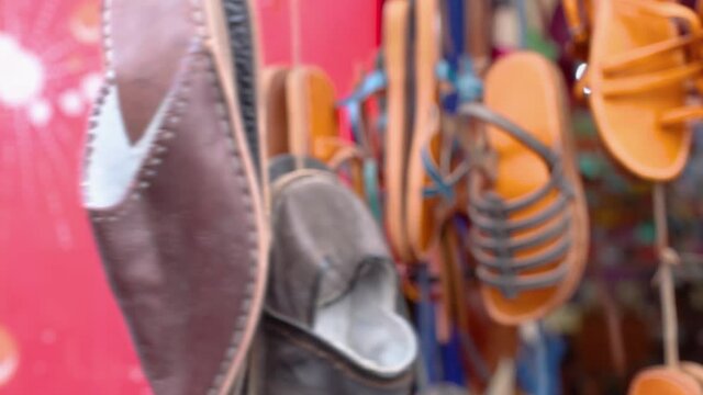 Traditional Oriental Moroccan Leather Slippers Called Babouche hang on the market counter, Essaouira, Morocco