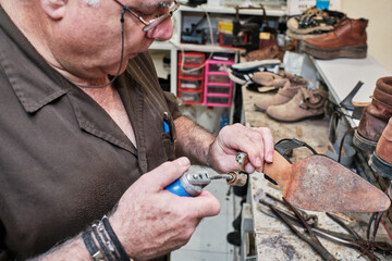 shoemaker man working in his shoe shop