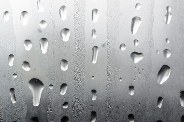 Macro photography of water drops on glass window white background after the rain