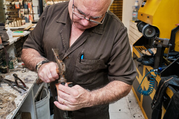 shoemaker man working in his shoe shop