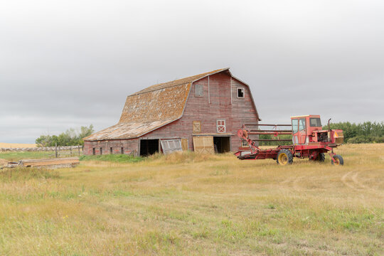 old barn and swather in a rural farmyard