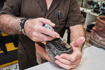 shoemaker man working in his shoe shop