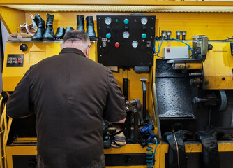 shoemaker man working in his shoe shop