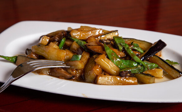 plate of aubergine with green beans. oriental cuisine. Isolated image.