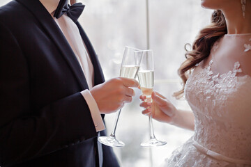 Bride and groom holding champagne glasses