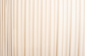 Cream-colored cloth, beige curtain fabric texture and background.