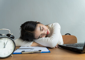 Work from home during the outbreak of the virus. the businesswoman work late at home and she sleeping because of fatigue on the table ,business concept.