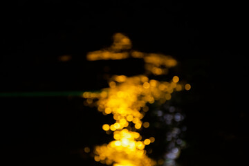 Beautiful blur bokeh light on the ripple of river surface