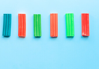 cute flower made of multi-colored plasticine clay on a pink background, multi-colored dough, minimal, children's crafts