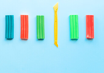 cute flower made of multi-colored plasticine clay on a pink background, multi-colored dough, minimal, children's crafts