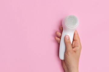 Top view of woman hand holding facial cleansing brush