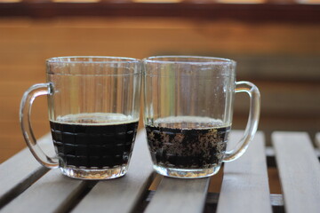 A pair of vintage mugs half-filled beer