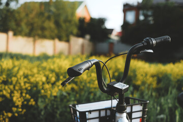 Fototapeta na wymiar Bicycle near the field with yellow flowers. Sports activities, outdoor recreation.