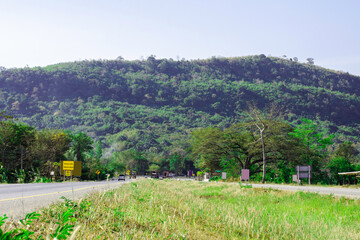 Beautiful green road in countryside, Landscape road with green forest, Main road on the mountain