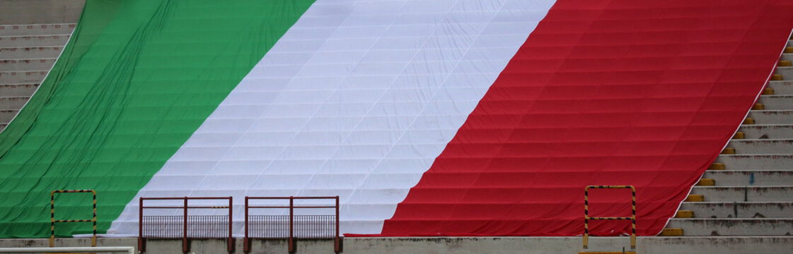 very big italian flag at stadium without people - Powered by Adobe