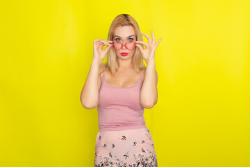 Blonde woman wearing sunglasses like hearts