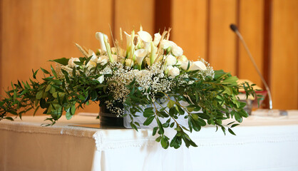 Fototapeta na wymiar pot of flowers in the altair in the church