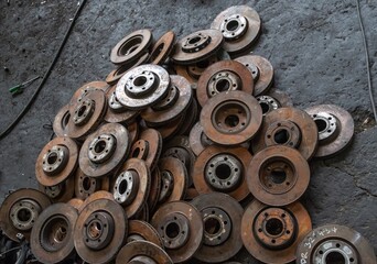 used brake rotor and car part at junkyard or scrapyard for recycling