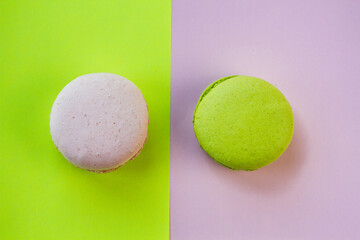 Many macaroons on a pink pastel background. Minimalism, eclairs and macaroons on a colored background