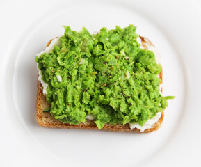 Classic english pea and ricotta toast on white plate