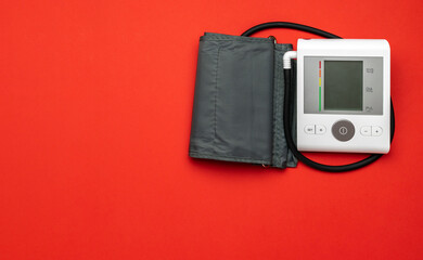 Blood pressure gauge. Heart patient test from doctor sphygmomanometer isolated on red background....