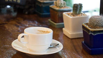 Obraz na płótnie Canvas White coffee mug with coffee shop background