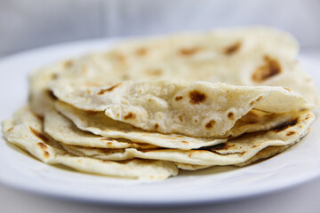 Classic homemade flour tortilla's on white plate