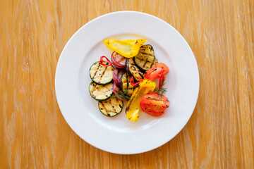 Grilled vegetable set with zucchini pepper tomatoes and onions. Top view.