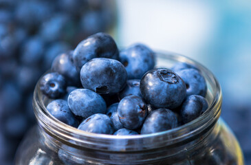Ripe blueberries in a jar close up