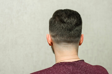 sport young guy with a modern trendy fadeback haircut for barbershop.