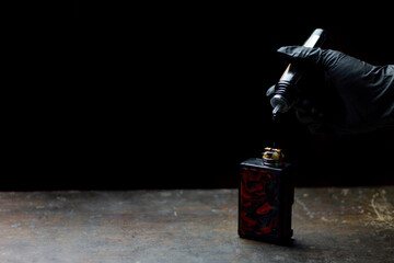 hand putting liquid of e-cig vape.