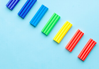 cute flower made of multi-colored plasticine clay on a pink background, multi-colored dough, minimal, children's crafts