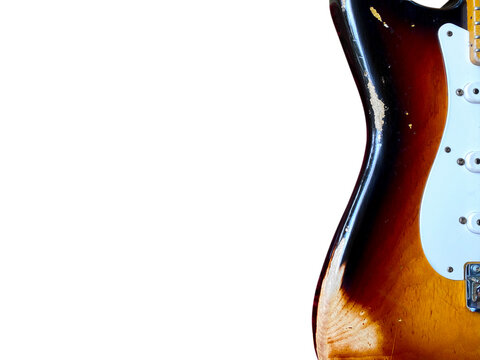 Close-up of a vintage relic sunburst electric guitar with nitrocellulose lacquer. Is a popular guitar and dream of guitarists around the world with copy space in left hand and clipping path on white.