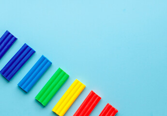 cute flower made of multi-colored plasticine clay on a pink background, multi-colored dough, minimal, children's crafts