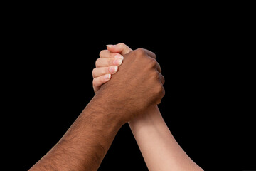 Holding hands brown and white people, man and woman on the black background. Support and...