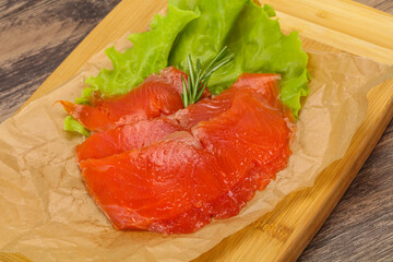 Sliced salmon fillet served rosemary