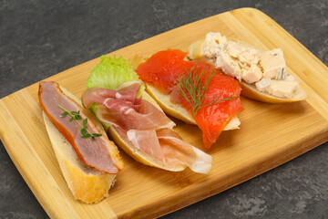 Tapas - bruschetta with prosciutto, salmon, duck and gorgonzola