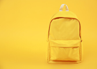 Yellow backpack empty space background,travel concept.Rucksack education symbol.Back to school.