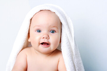 Baby portrait closeup,cute child face.Kid's body care,girl in towel.