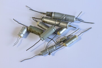 old electronic parts, capacitors on a white background