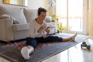 Pretty spanish girl practice gymnastics at home in the living room and doing a pause