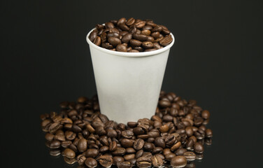Paper cup of coffee and coffee beans on table