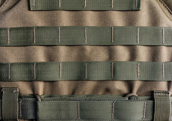 Military olive colored modern armor vest with molle system.